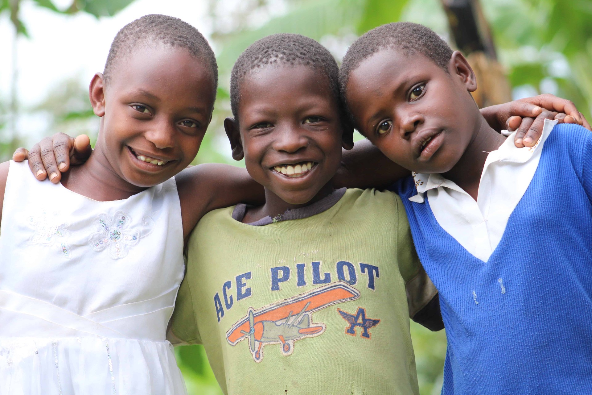 Three smiling Berakhah children embracing